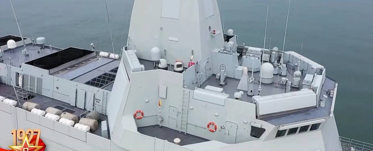 What appears to be multiple sensor turrets with electro-optical and infrared full-motion video cameras, as well as a navigation radar and host of other antennas commonly associated with various communications systems are seen in this wide shot of the top of the <em>Nanchang</em>. Also visible here are some of the destroyer's life rafts, contained within white canisters along the upper deck behind the bridge section, and some of the ship's flush-mounted exhaust stacks in the center of the superstructure aft of the mast. <em>Chinese internet</em>