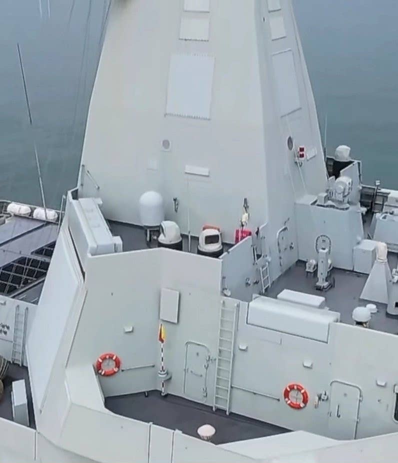 Two rectangular fixed-face antennas associated with <em>Nanchang</em>'s X-band radar are seen toward the base of its integrated mast. Smaller fixed-face antennas on the mast, mounted above the ones tied to the X-band radar, may be part of an electronic warfare system or other radars. One of the large rear-facing antennas for the Type 364B radar is also visible at the bottom left corner of this image. <em>Chinese internet</em>