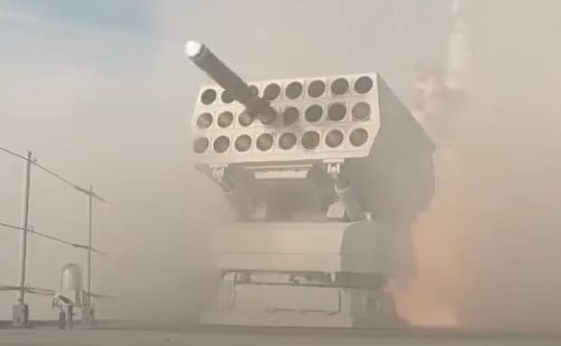 A screengrab from an earlier Chinese state television broadcast showing a Type 726-series launcher on a Type 055 destroyer firing either a decoy of some kind or an anti-submarine rocket. <em>CCTV capture via YouTube</em>