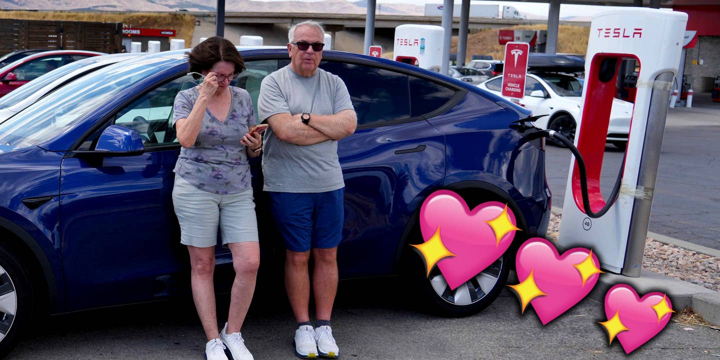 A couple stand by a Tesla Supercharger, with hearts overlaid on top.