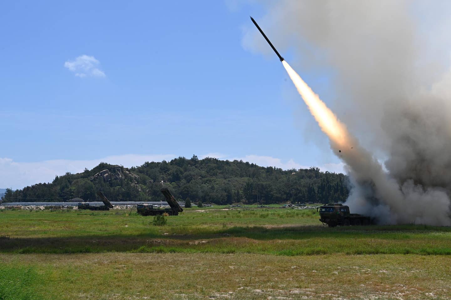 Multiple rocket launchers, apparently 370mm caliber <a href="https://weaponsystems.net/system/481-PHL16">PHL-16s</a>, from the Eastern Theater Command of the Chinese PLA conduct long-range live-fire drills in the Taiwan Strait, August 4, 2022. <em>Photo by Lai Qiaoquan/Xinhua via Getty Images</em>