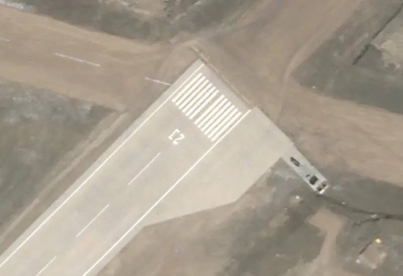 Vehicles and/or heavy equipment at the northern end of the runway on September 8, 2020. <em>PHOTO © 2022 PLANET LABS INC. ALL RIGHTS RESERVED. REPRINTED BY PERMISSION</em>