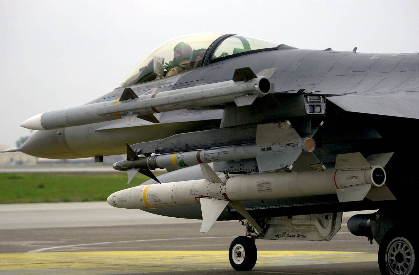 An F-16CJ taxis with an AGM-88 HARM under its wing, as well as an AIM-9M Sidewinder on a pylon with a towed decoy housing, an AIM-120C AMRAAM on the wingtip, and an electronic warfare pod under its belly. (USAF image)