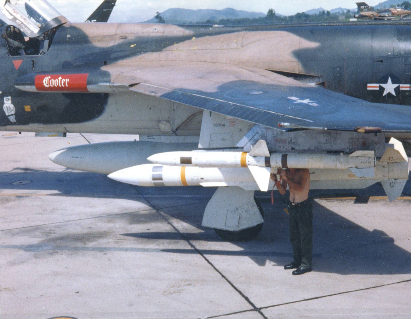 A U.S. Air Force armorer preparing an AGM-45 Shrike missile carried by an F-105G Thunderchief during the war in Southeast Asia. Just behind him is an AGM-78 Standard missile. <em>U.S. Air Force</em>