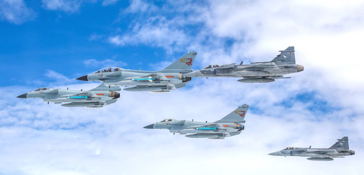 Chinese J-10 and Thai Gripen fighter jets fly together during Exercise Falcon Strike 2019. <em>China Military / Xie Zhongwu and Zhou Yongheng</em>