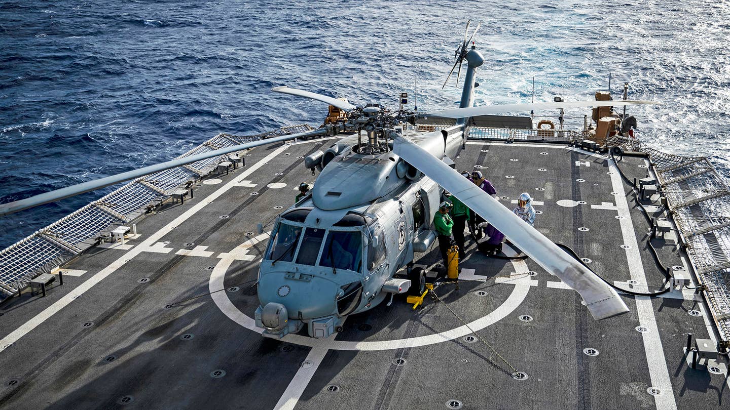Navy Embarked MH-60R Helicopter Aboard Coast Guard Cutter