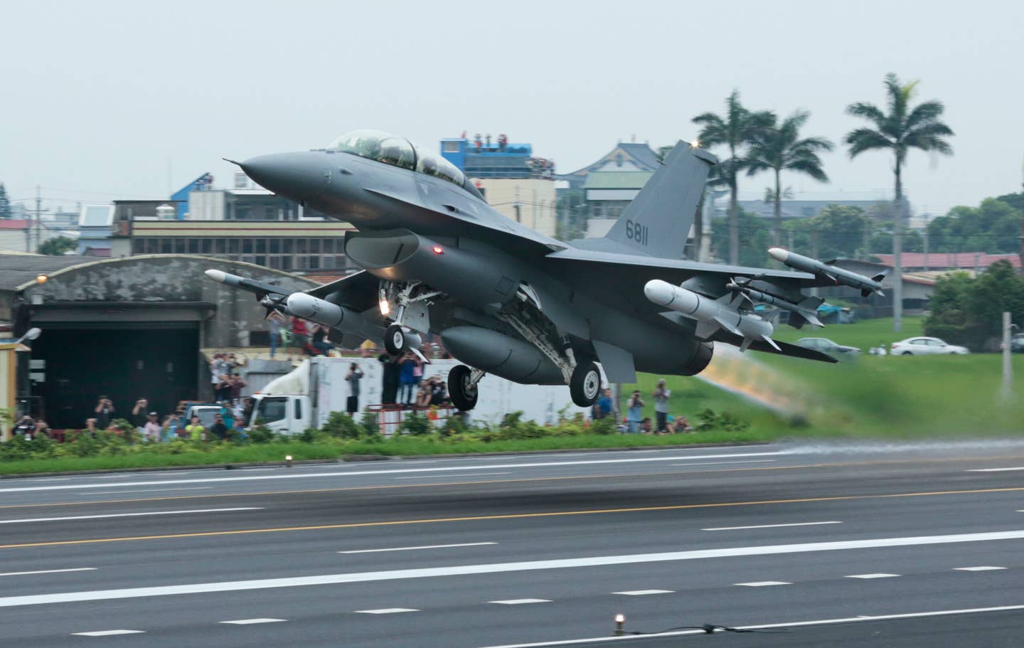 A ROC Air Force F-16 takes off armed with Harpoon anti-ship missiles during an anti-invasion drill conducted from the highway at Chang-Hua in 2019. <em>Photo by Patrick Aventurier/Getty Images</em>