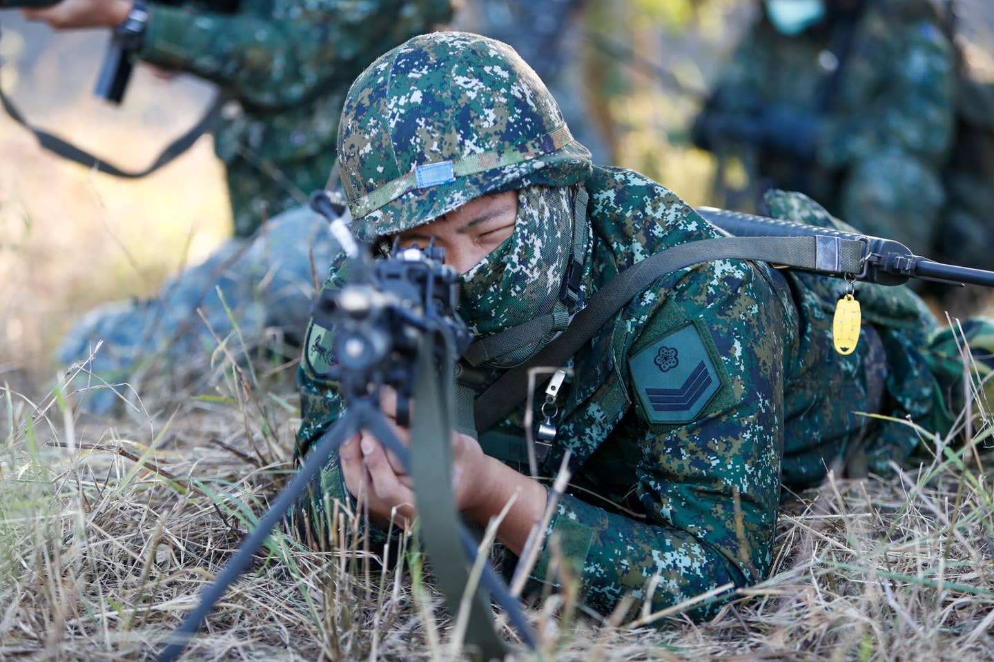 Soldiers holding machine guns and grenade launchers in position, during a shore defense operation as part of a military exercise simulating the defense against the intrusion of the Chinese military, amid rising tensions between Taipei and Beijing, in Tainan, Taiwan, 11 November 2021. <em>Photo by Ceng Shou Yi/NurPhoto via Getty Images</em>
