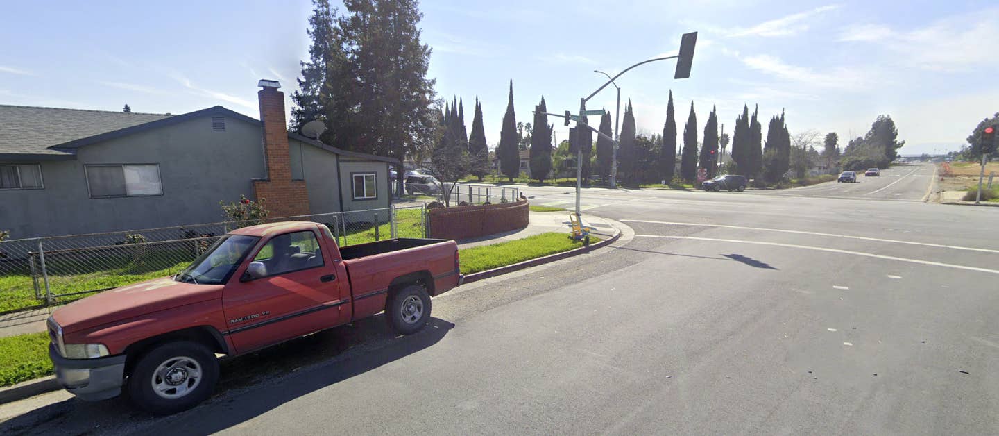 Minter's house can be seen on the left, in the direct line of fire from the highway offramp across the road. Minter says cars turning right, particularly from the center lane, are often the ones that end up hitting his house. <em>Google Maps</em>