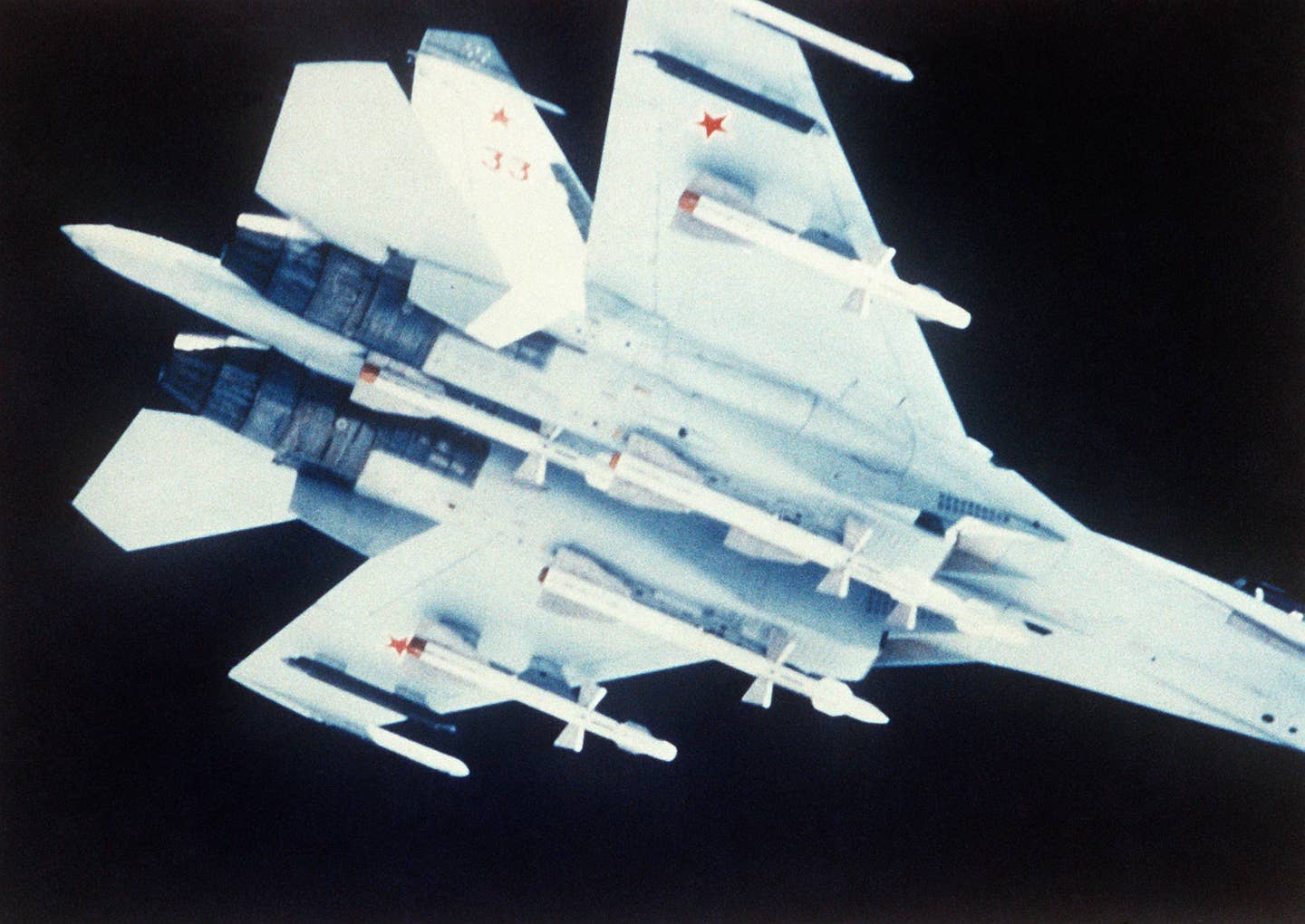 A very early encounter with a Soviet Su-27, photographed from a NATO aircraft. The Soviet fighter carries infrared-guided R-27Ts under its wings and radar-guided R-27Rs below the fuselage and engine intakes. <em>U.S. Department of Defense</em>