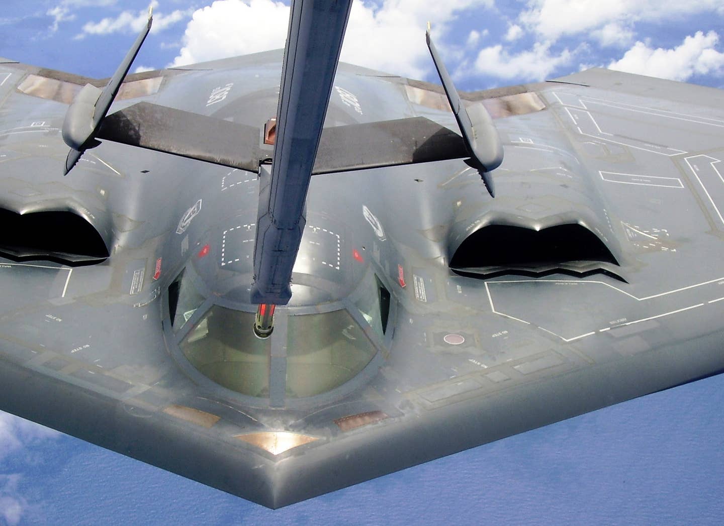 A B-2 Spirit bomber receives fuel from a KC-10 Extender during a training mission near Andersen Air Force Base, Guam. <em>U.S. Air Force photo/Senior Airman Melissa Perry</em>