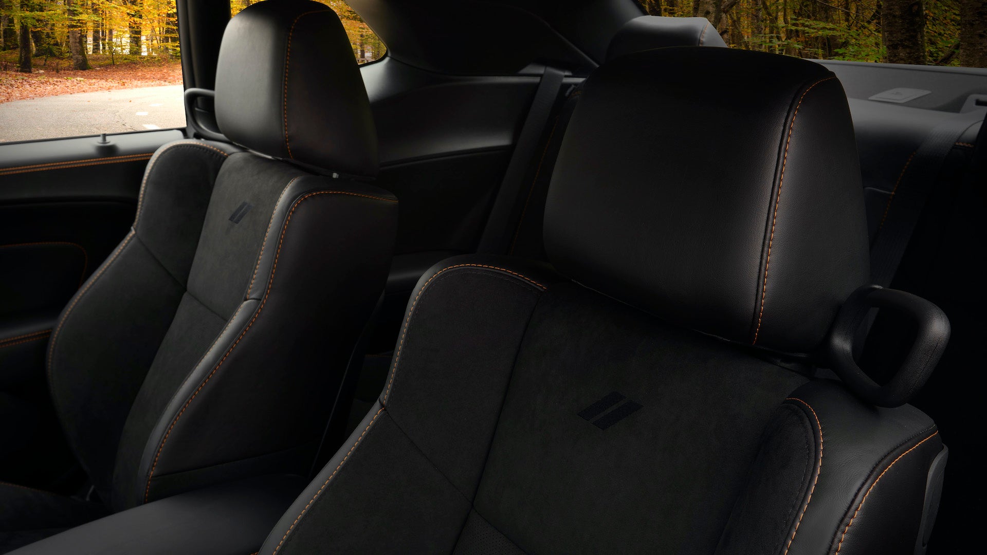 Seats sport orange stitching on the HEMI® Orange appearance package, as well as a monochromatic Dodge Rhombi seatback logo (shown on 2022 Dodge Challenger GT RWD).