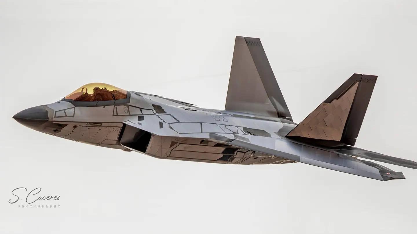 The initial F-22 'chrome Raptor' with larger tile areas and sheet-like panels of material affixed to its skin.<em> Credit: Santos Caceres&nbsp;</em>