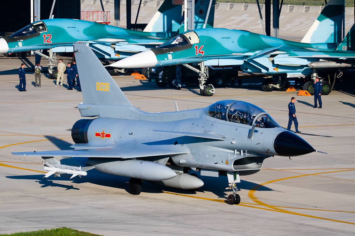 A two-seat J-10S armed with PL-8 missiles on the outboard underwing pylons during an exercise with the Russian Aerospace Forces. <em>Russian Ministry of Defense</em>