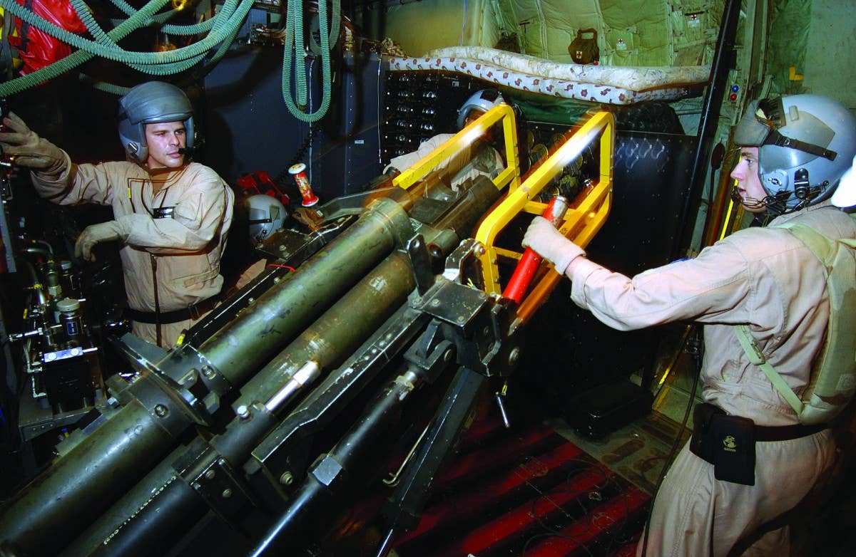 A picture of an M102 howitzer inside an AC-130U gunship, showing the single recoil cylinder on top. <em>USAF</em>