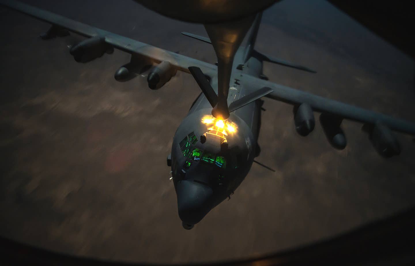 An AC-130J Ghostrider gunship links up with a KC-135 aerial refueling tanker somewhere in the Middle East in 2020. <em>USAF / Staff Sgt. Trevor T. McBride</em>
