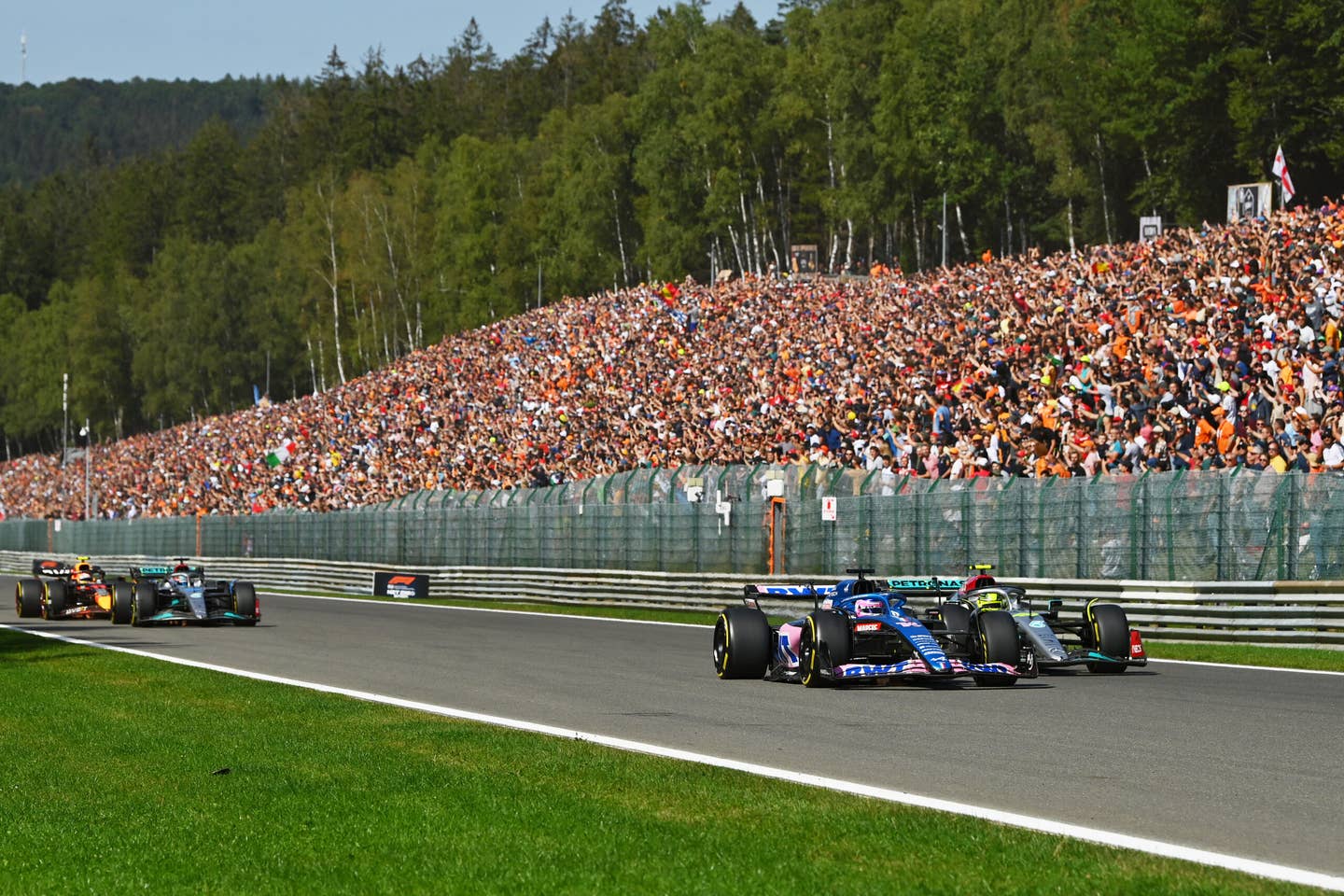 Fernando Alonso and Lewis Hamilton on the opening lap of the 2022 Belgian GP. <em>Getty</em>