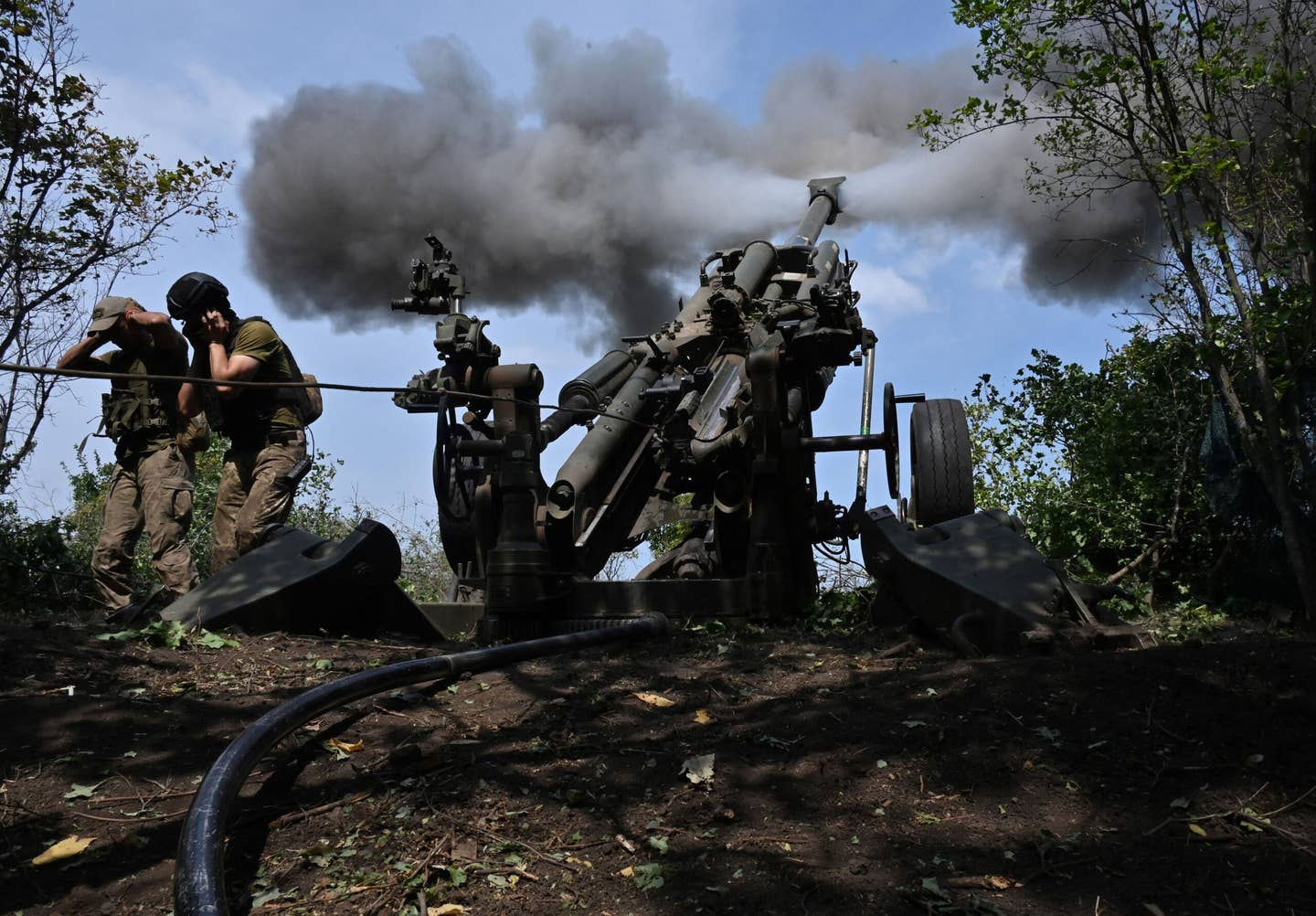 Ukrainian troops fire a U.S.-made M777 howitzer from their position on the front line in Kharkiv region in August. <em>SERGEY BOBOK/AFP via Getty Images</em>