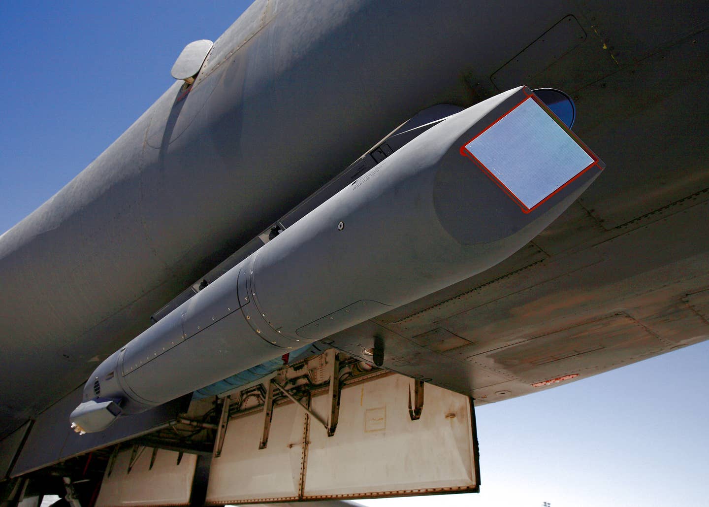 A sniper pod is mounted on the lower right of a B-1B Lancer fuselage. The sniper pod allows the aircrew to positively identify a target and quickly assess battle damage after an attack. (U.S. Air Force photo/Jet Fabara)