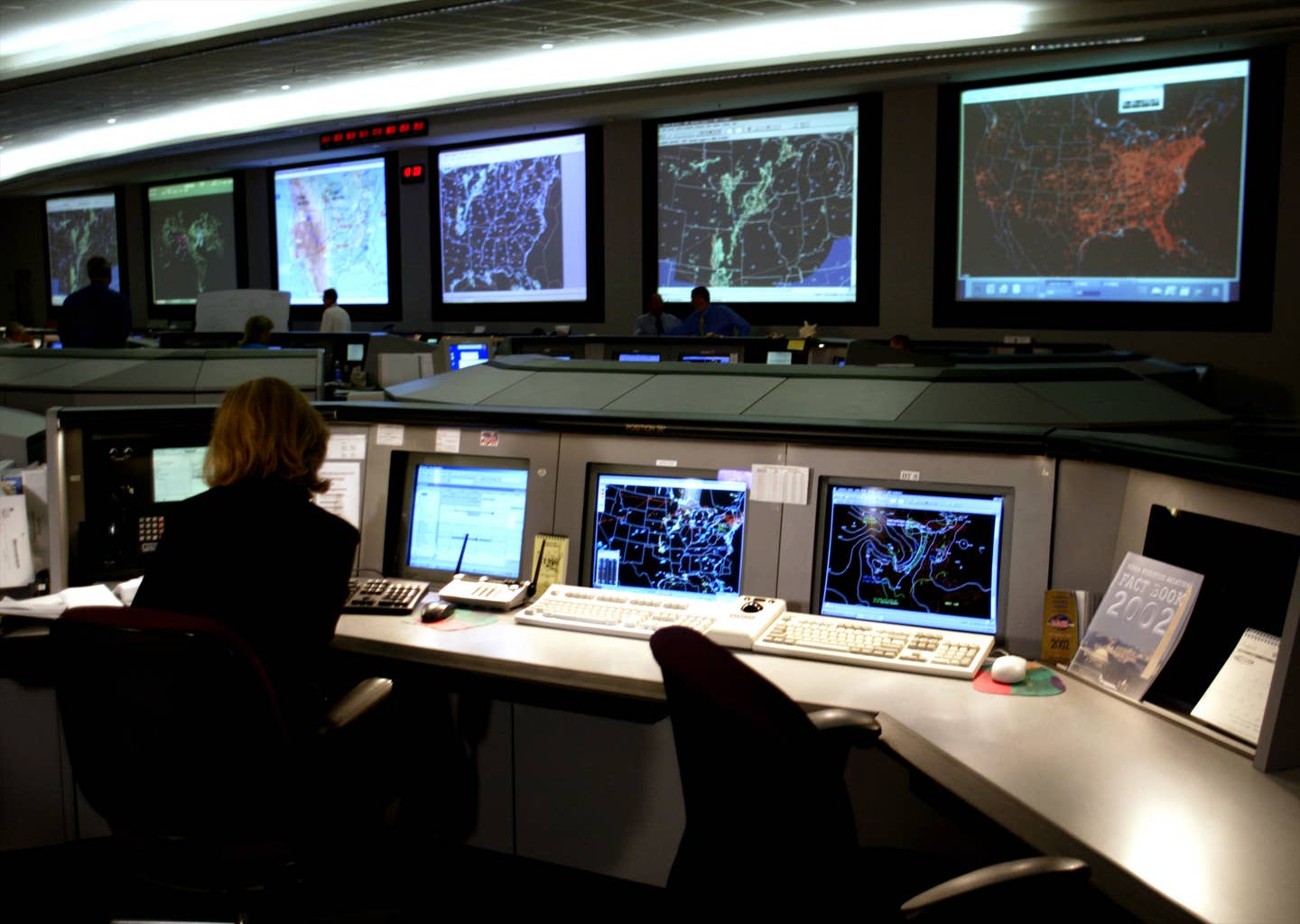 Federal Aviation Administration employee keeps track of 5000 aircraft in the air over the United States at the System Command Center 12 August 2002 in Herndon, Virginia. The command center was central in the September 11th terrorist incident and was responsible for grounding all planes after the attack became known. <em>Credit: Photo credit should read STEPHEN JAFFE/AFP via Getty Images</em>