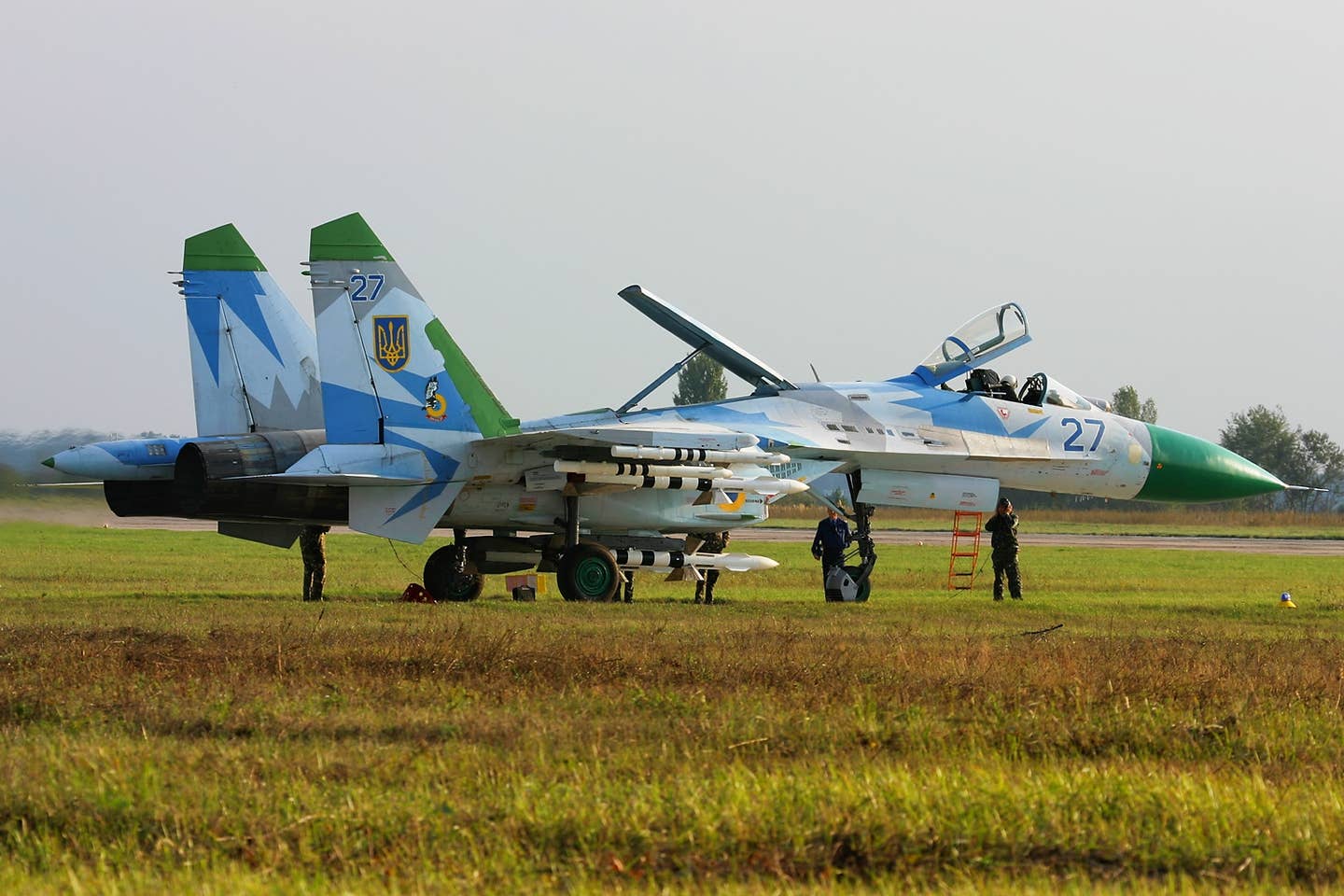 A Ukrainian Air Force Su-27 with a green radome and tailfin caps at Kyiv-Gostomel Airport in September 2008. <em>Oleg V. Belyakov/Wikimedia Commons</em>