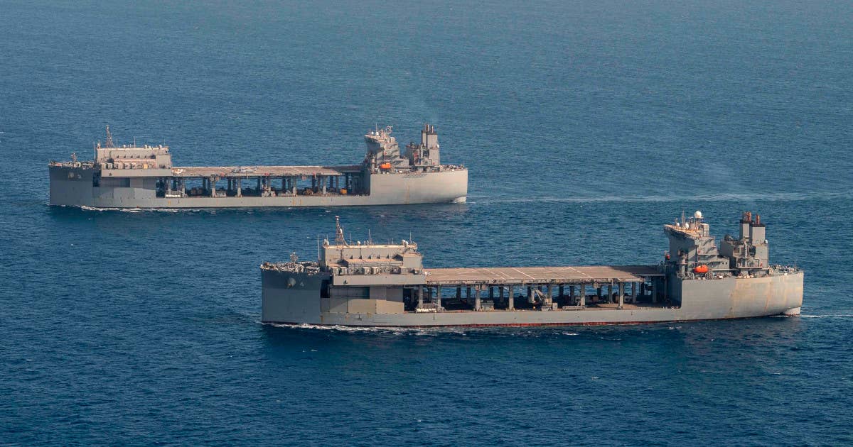 The US Navy's <em>Lewis B. Puller</em> class expeditionary sea bases have ample room on their upper flight deck, as an open lower deck below it, to accommodate containerized systems like the EMWMS. This picture shows two of these ships, the USS <em>Hershel "Woody" Williams</em>, in front, and the USS <em>Lewis B. Puller</em>, behind. <em>USN</em>