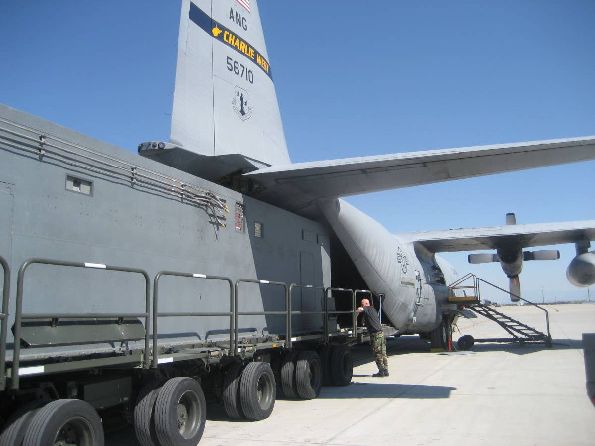 A Senior Scout containerized signals intelligence system is loaded onto an Air National Guard C-130H Hercules. <em>USAF</em>