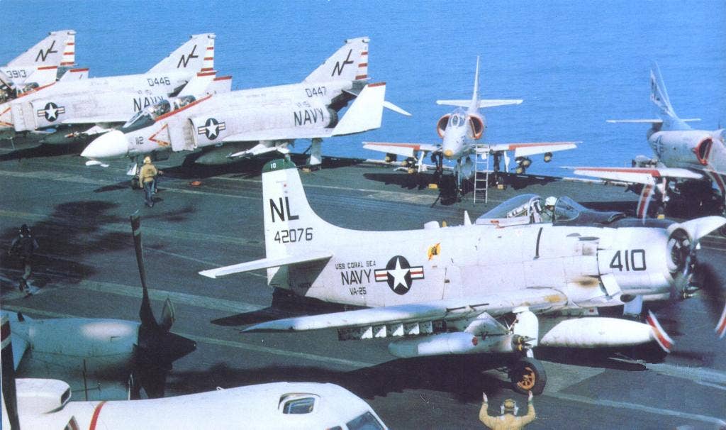 The big piston-powered Skyraider shared carrier decks with then state-of-the-art fast jets during Vietnam. Here a Douglas A-1J&nbsp;<em>Skyraider</em> of VA-25 is seen&nbsp;on the carrier&nbsp;<em>USS Coral Sea </em>(CVA-43)&nbsp;in 1967.&nbsp;