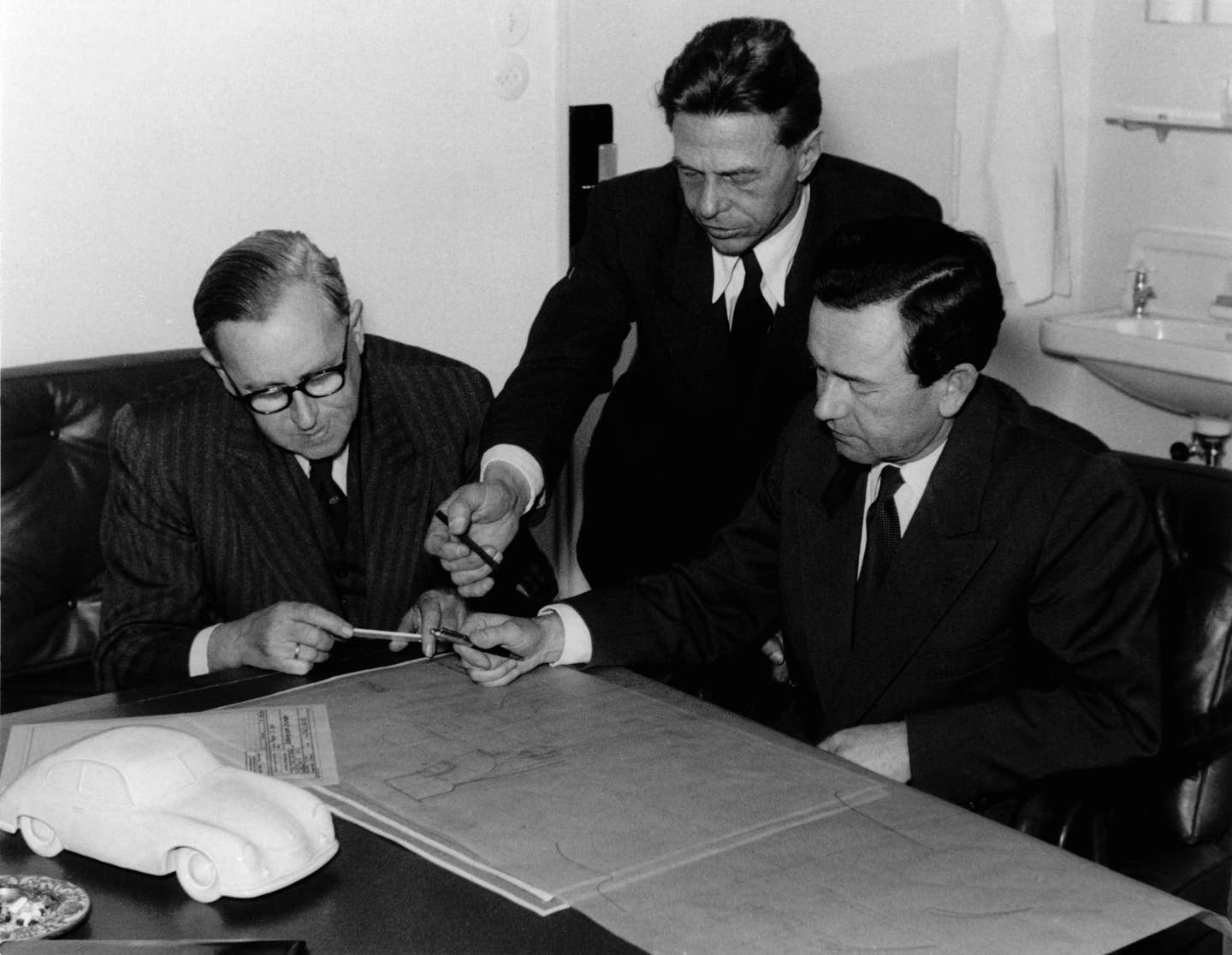 Ferry Porsche (left), Erwin Komenda (center) and Karl Rabe (right) working at Porsche