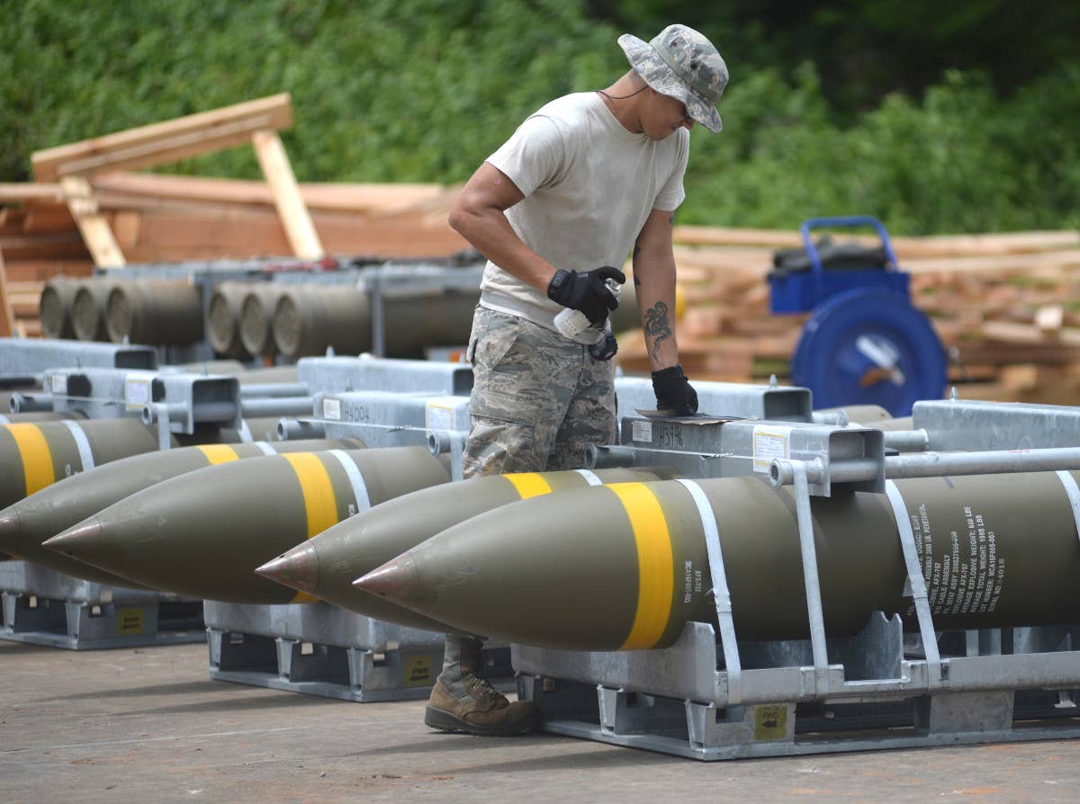 A member of the US Air Force marks munitions before they are moved into storage sites at Andersen Air Force Base on Guam. <em>USAF</em>.