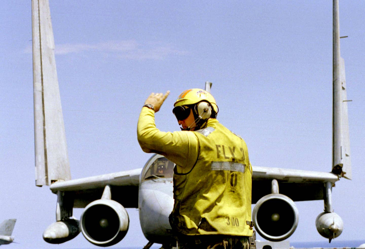 The Fly 3 Petty Officer directs an S-3B Viking from VS-24 as it folds its wings on the flight deck of the USS <em>Theodore Roosevelt</em> (CVN-71) on May 5, 1999, after completing an Operation Allied Force mission over the former Yugoslavia. <em>Petty Officer 3rd Class Donne McKissic/USN</em>