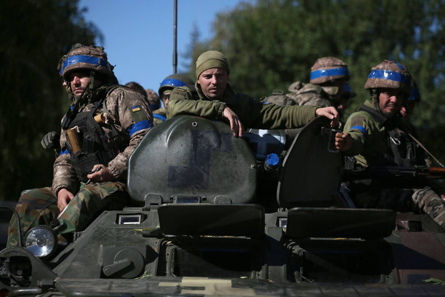 Ukrainian soldiers sit on an armored personnel carrier (APC) on their way to the frontline against Russian troops in the Donetsk region on September 21, 2022. <em>Photo by ANATOLII STEPANOV/AFP via Getty Images</em>
