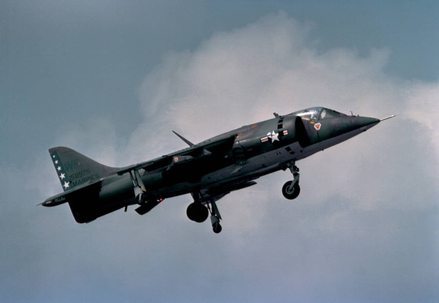 An AV-8A Harrier from Marine Attack Squadron 513 (VMA-513) preparing to land, with its nozzles deflected fully downward. U.S. Marine Corps pilots pioneered the VIFF maneuver. <em>National Archives</em>
