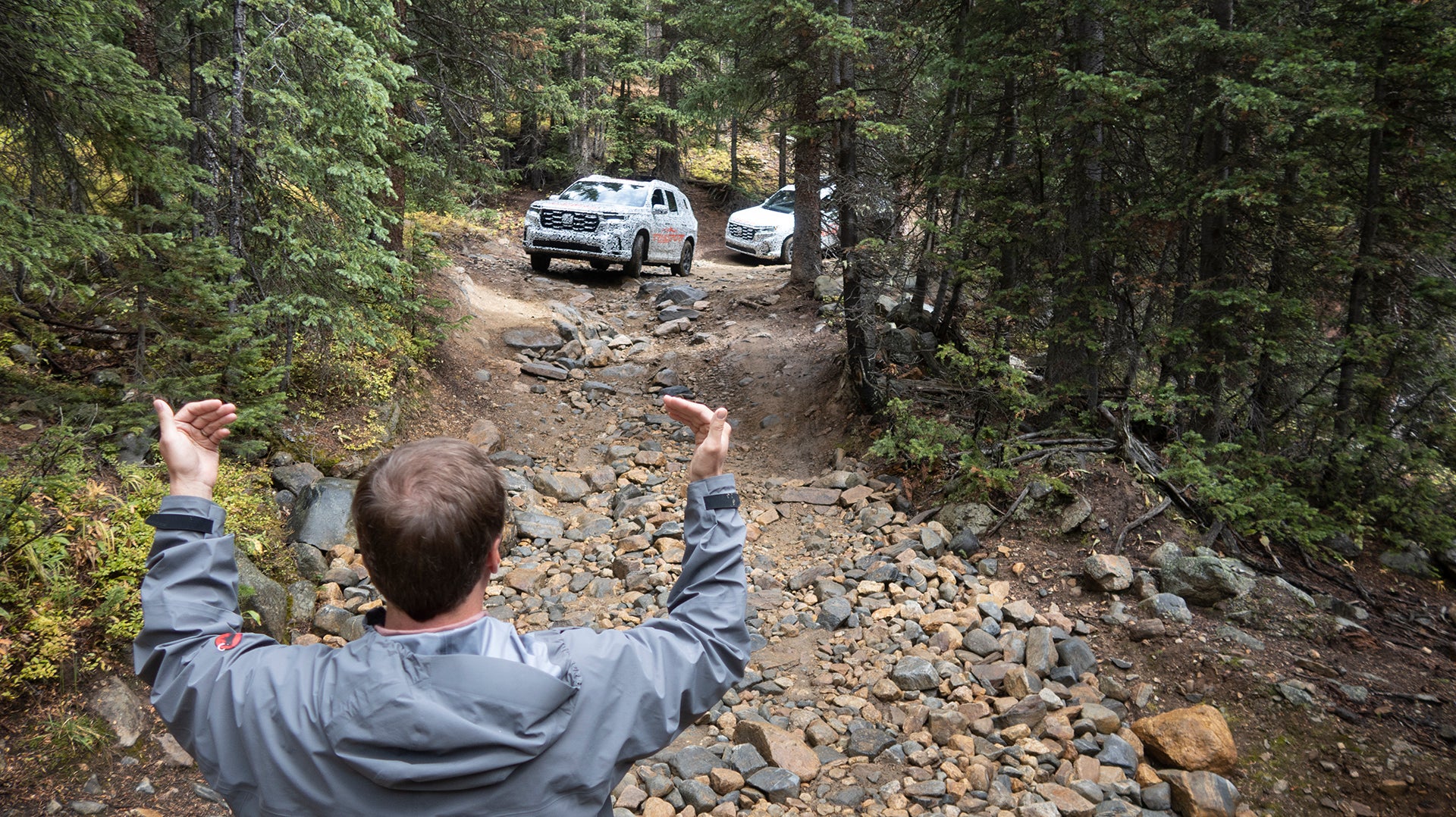 2023 Honda Pilot TrailSport being directed on a trail by a spotter.