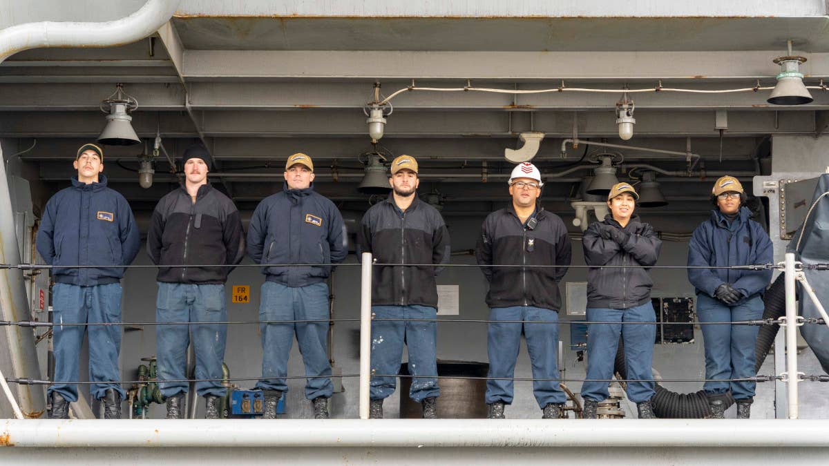 Deck department Sailors assigned to the USS <em>Gerald R. Ford</em> stand by as the carrier departs Naval Station Norfolk. <em>USN / Mass Communication Specialist 1st Class Anderson W. Branch</em>