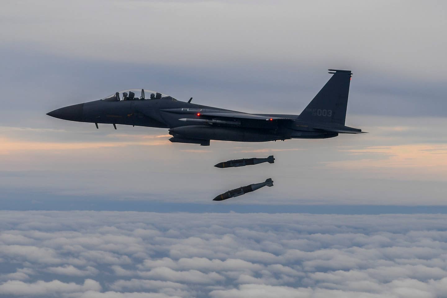 A photo released by the South Korean Defense Ministry shows a ROKAF F-15K dropping two Joint Direct Attack Munition (JDAM) bombs onto an island target in response to the North Korean IRBM launch earlier in the day, on October 4, 2022. <em>Photo by South Korean Defense Ministry via Getty Images</em>