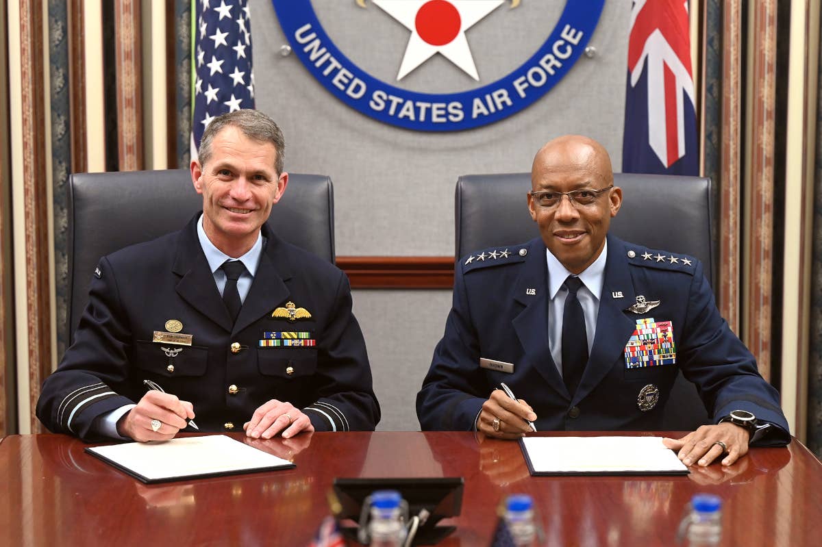 U.S. Air Force Chief of Staff Gen. Charles Q. Brown, at right, and Royal Australian Air Force Air Marshal Rob Chipman, at left, sign the new Joint Vision Statement on September 14, 2022. <em>USAF / Andy Morataya</em>