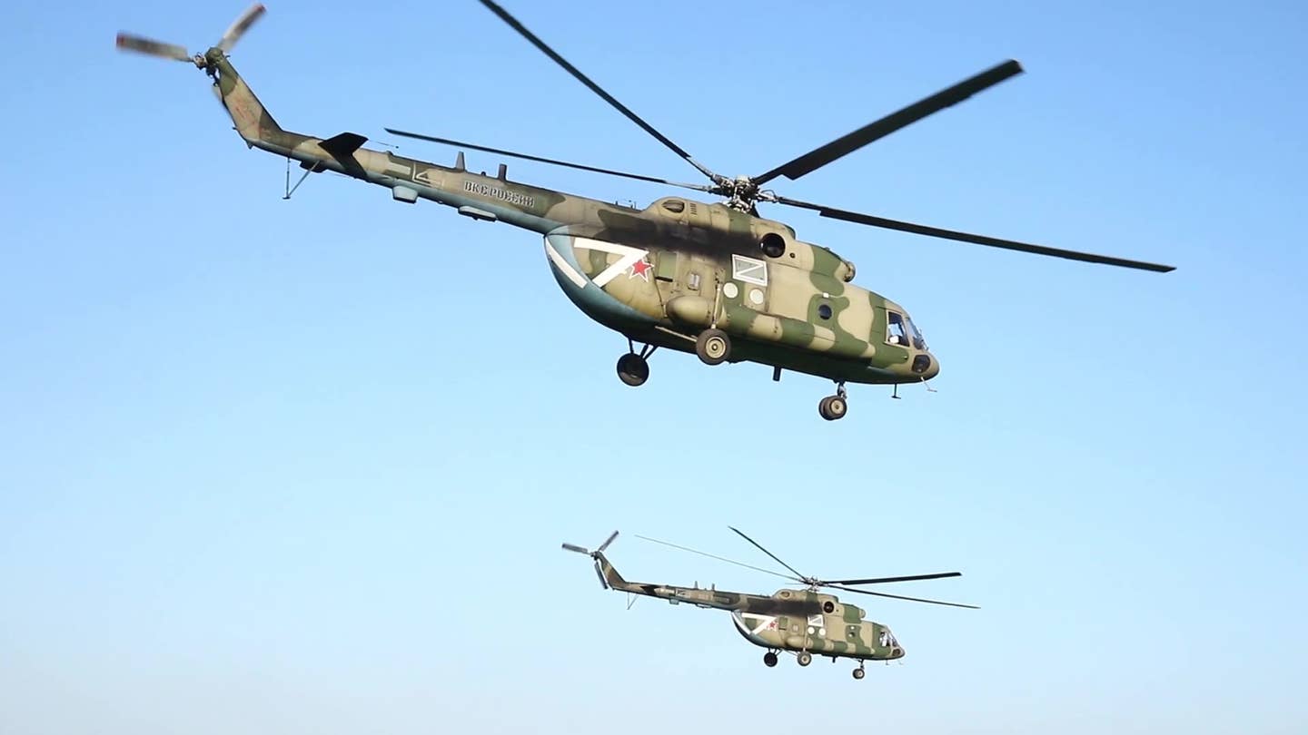 A pair of Mi-8MTPR-1 helicopters with the Rychag system for jamming air defense radars takes off. <em>Russian Ministry of Defense</em>