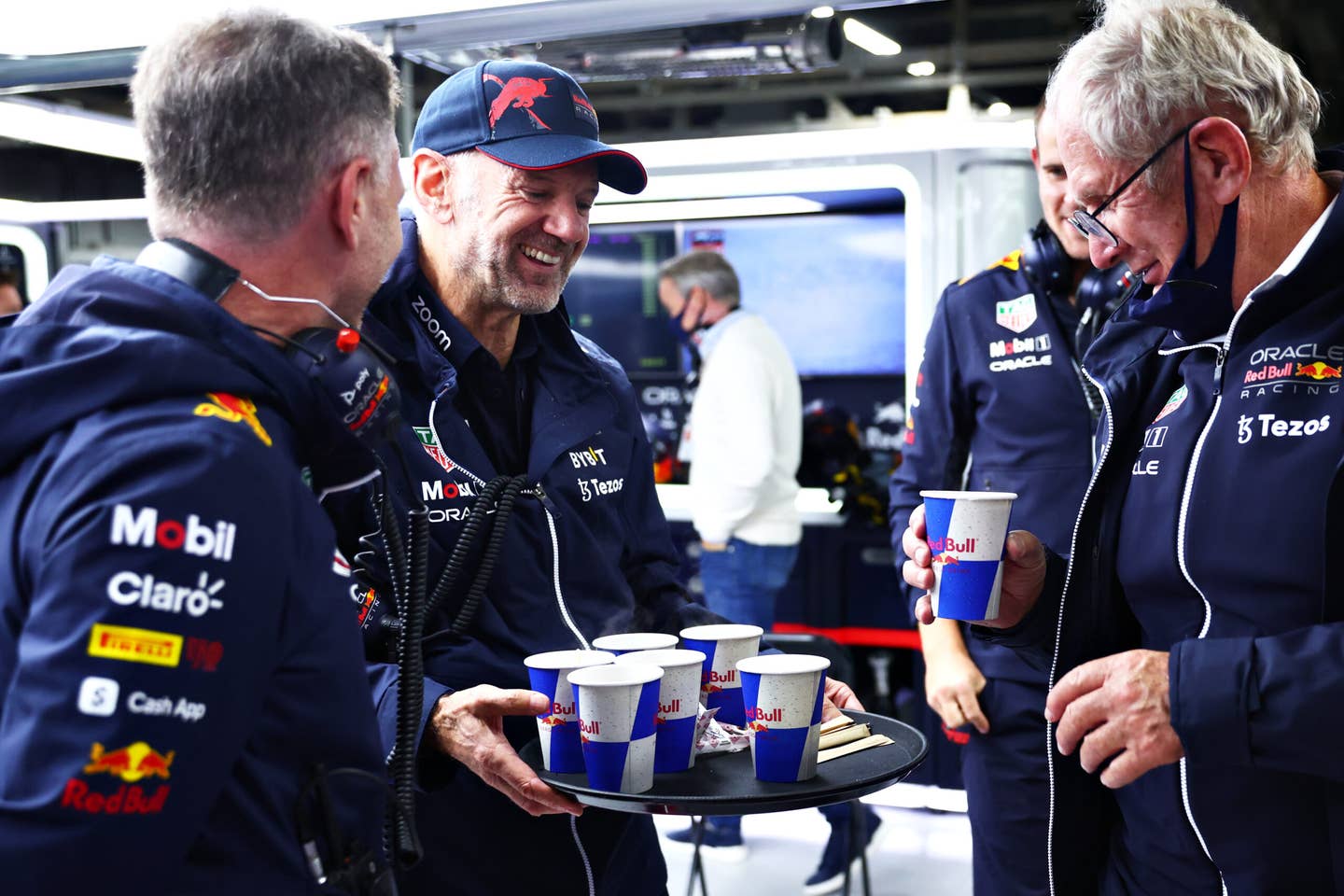 SUZUKA, JAPAN - OCTOBER 09: Adrian Newey, the Chief Technical Officer of Red Bull Racing delivers hot drinks to Red Bull Racing Team Principal Christian Horner and Red Bull Racing Team Consultant Dr Helmut Marko during a red flag delay during the F1 Grand Prix of Japan at Suzuka International Racing Course on October 09, 2022 in Suzuka, Japan. (Photo by Dan Istitene/Getty Images)