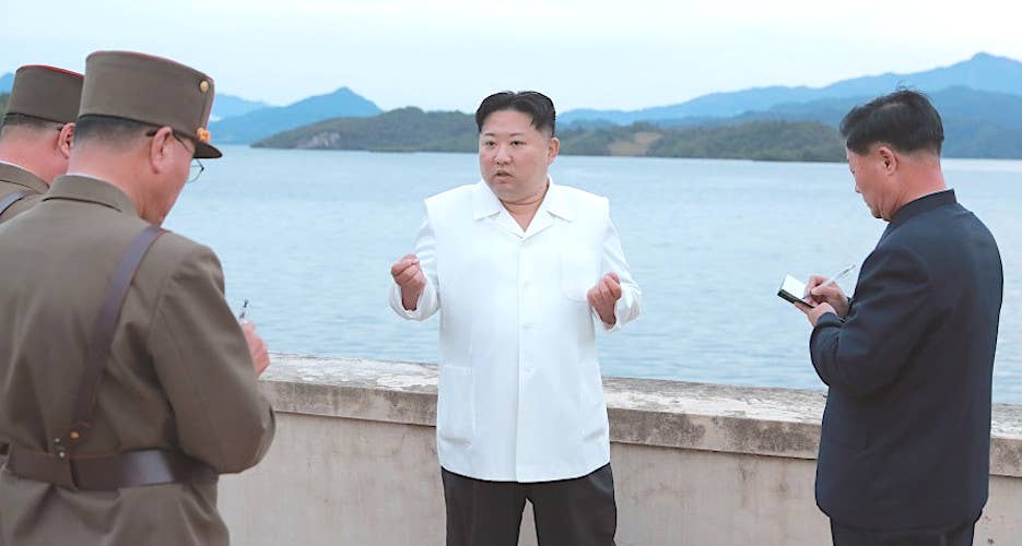 A picture that shows North Korean leader Kim Jong Un giving 'field guidance' to military officers and officials at the reservoir where the missile launch was conducted on September 25, 2022. <em>KCNA</em>