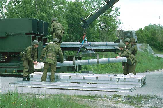 Soldiers load AIM-120s training rounds into a NASAMS launcher. (Public Domain)