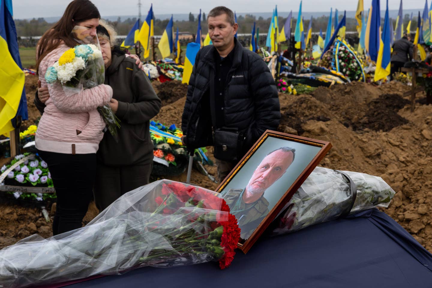 Relatives grieve by the coffin of  Oleksandr Kopylov, 58, who was a soldier missing in action since July 25th in Dementilvka in Kharkiv district during his funeral on Sept. 28 in Kharkiv. (Photo by Paula Bronstein/Getty Images)