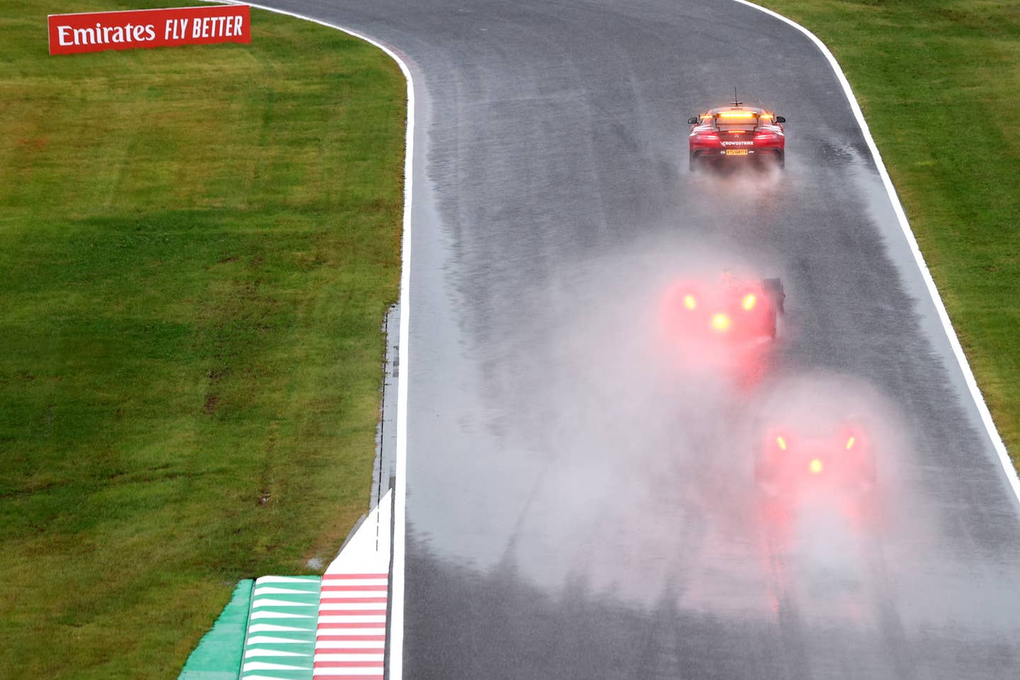 Look at the difference in spray—Safety car is leading two F1 cars | Photo by Clive Rose/Getty Images
