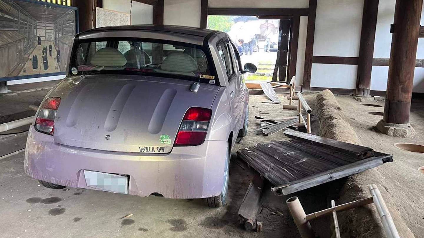 Toyota WiLL Vi that has crashed into Japan's oldest outhouse