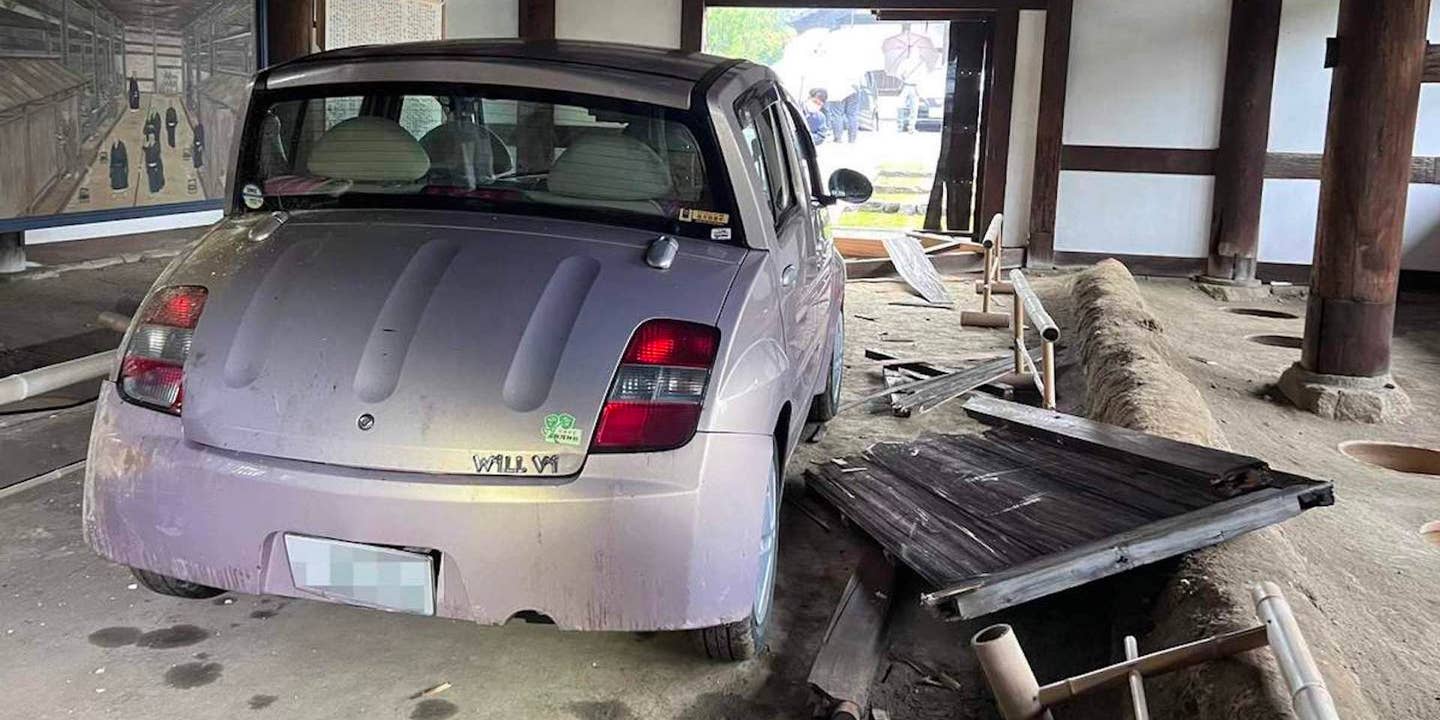 Toyota WiLL Vi that has crashed into Japan's oldest outhouse
