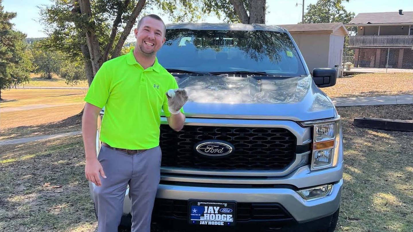 Austin Clagett poses next to the 2022 Ford F-150 4x4 crew cab he won at a golf tournament