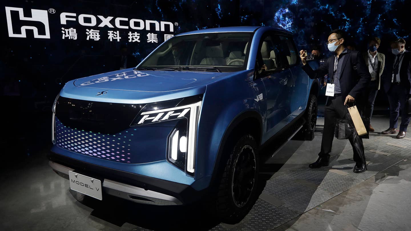 People look at the Foxtron Model V electric car during the 2022 Hon Hai Tech Day at the Nangang Exhibition Center in Taipei, Taiwan, on Oct. 18. (AP Photo/Chiang Ying-ying)