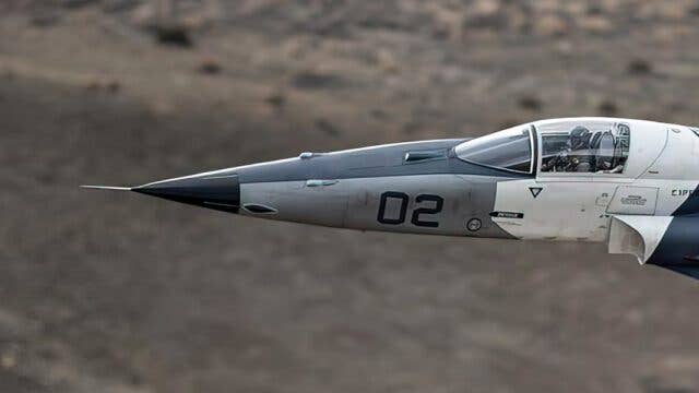 A zoomed-in shot of the F-5AT flight testing the TacIRST. The forward-staring device can be seen directly in front of the cockpit windscreen. <em>Credit: TacAir</em>