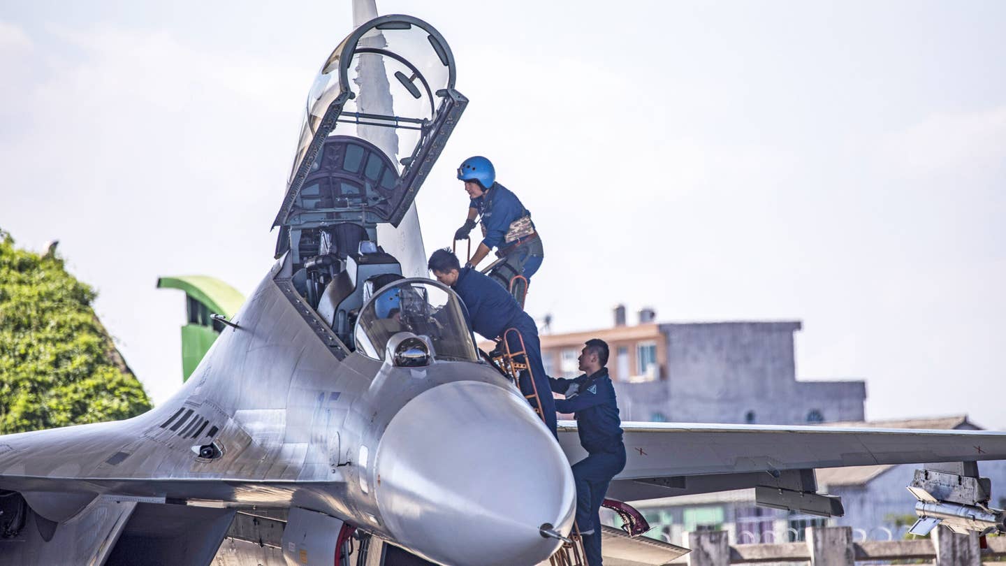 PLA Naval Aviation pilots board a Flanker series fighter before taking off from a PLA military airbase for a training session in east China’s Zhejiang Province in late August 2021. <em>Feature China/Future Publishing via Getty Images</em>