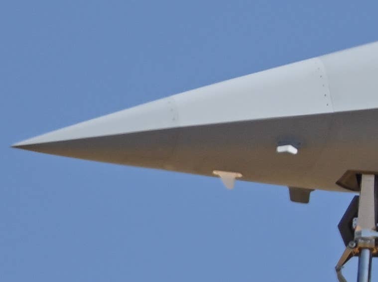 From the side, it's not entirely clear if the new antenna on the right side of the nose is attached to the visibly 'sectioned' portion of the nose or not, but the one on the left clearly is. <em>@Task_Force23</em>